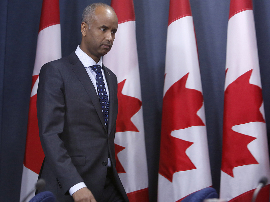 Ahmed Hussen, Minister of Immigration, Refugees and Citizenship gets ready to hold a news conference to update Canadians on the possible impacts of recent immigration-related decisions made by President Donald Trump, in Ottawa on Sunday, January 29, 2017. THE CANADIAN PRESS/Fred Chartrand ORG XMIT: FXC102